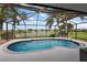 Inviting screened-in pool area with views of a serene lake, creating a perfect outdoor oasis at 5412 County Road 125, Wildwood, FL 34785