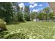 Large backyard with a shed and well-maintained lawn at 5460 Sw 103Rd Street Rd, Ocala, FL 34476