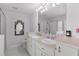 Bright bathroom with double sinks, large mirror and a glass-enclosed shower at 5460 Sw 103Rd Street Rd, Ocala, FL 34476