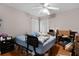 Bedroom with hardwood floors and standard ceiling fan at 5460 Sw 103Rd Street Rd, Ocala, FL 34476