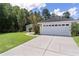 Charming home with a pristine two-car garage and well-manicured lawn, framed by lush greenery at 5460 Sw 103Rd Street Rd, Ocala, FL 34476