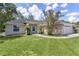 This lovely single story home has an attached two car garage, mature landscaping, and a green lawn at 5460 Sw 103Rd Street Rd, Ocala, FL 34476