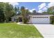 Charming home boasts a well-manicured lawn, inviting walkway, and attached two-car garage at 5460 Sw 103Rd Street Rd, Ocala, FL 34476