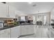 Bright kitchen features white cabinets, black countertops, modern appliances, and a breakfast nook at 5460 Sw 103Rd Street Rd, Ocala, FL 34476