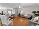 Bright living room features hardwood floors, neutral paint, and a ceiling fan at 5460 Sw 103Rd Street Rd, Ocala, FL 34476