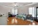 Spacious main bedroom with hardwood floors, ceiling fan, and ample natural light at 5460 Sw 103Rd Street Rd, Ocala, FL 34476