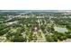 An aerial photo shows the property nestled among trees and a neighborhood close to a pond at 601 S 12Th St, Leesburg, FL 34748