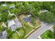 An aerial view displays the property boundaries, lush green trees, and location relative to nearby streets at 601 S 12Th St, Leesburg, FL 34748