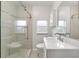 Modern bathroom with a glass enclosed shower and a vanity with a white countertop at 601 S 12Th St, Leesburg, FL 34748