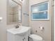 Bright bathroom featuring a vanity with a white countertop and a window above the toilet at 601 S 12Th St, Leesburg, FL 34748