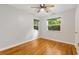 Bedroom featuring natural light from multiple windows, hardwood floors, and a ceiling fan at 601 S 12Th St, Leesburg, FL 34748