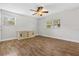 Spacious bedroom with hardwood floors and a ceiling fan, filled with ample natural light at 601 S 12Th St, Leesburg, FL 34748