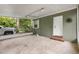 A spacious carport features a concrete floor, access door and a view of the natural surroundings at 601 S 12Th St, Leesburg, FL 34748