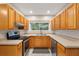 Well lit kitchen features stainless steel appliances, bright countertops, and light-colored wood cabinets at 601 S 12Th St, Leesburg, FL 34748