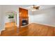 Spacious living room featuring hardwood floors, a brick fireplace, and abundant natural light at 601 S 12Th St, Leesburg, FL 34748