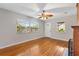 Bright living room with hardwood floors and natural light streaming through the double paned windows at 601 S 12Th St, Leesburg, FL 34748