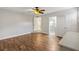 Open main bedroom with hardwood floors leading to the ensuite bathroom and closets at 601 S 12Th St, Leesburg, FL 34748