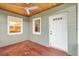 Covered porch with a light green painted brick base, a wooden ceiling and great natural light at 601 S 12Th St, Leesburg, FL 34748