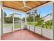 Screened porch with a wooden ceiling and a view of the neighborhood at 601 S 12Th St, Leesburg, FL 34748