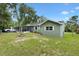 An expansive backyard includes a fenced perimeter, utility shed and a screen-enclosed porch area at 601 S 12Th St, Leesburg, FL 34748