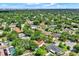 An aerial view of a picturesque residential area with lush tree coverage, private pools, and a view of a well-maintained golf course nearby at 6316 Marlberry Dr, Orlando, FL 32819