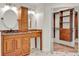 Well-lit bathroom featuring a vanity with granite countertops and a linen closet at 6316 Marlberry Dr, Orlando, FL 32819