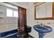 Bathroom featuring pedestal sink, tub and tiled walls at 6316 Marlberry Dr, Orlando, FL 32819