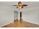 Bedroom showcasing hardwood floors, a ceiling fan, closet, and doorway at 6316 Marlberry Dr, Orlando, FL 32819