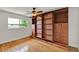 Bedroom featuring custom built-in shelving and drawers, hardwood floors, and a ceiling fan at 6316 Marlberry Dr, Orlando, FL 32819
