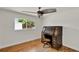 Bedroom featuring wood floors, ceiling fan, and window at 6316 Marlberry Dr, Orlando, FL 32819