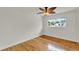 Bright bedroom featuring hardwood floors, a ceiling fan, and a window offering natural light at 6316 Marlberry Dr, Orlando, FL 32819
