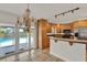 Bright kitchen area with natural wood cabinets and access to the outdoor pool area at 6316 Marlberry Dr, Orlando, FL 32819