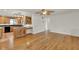 Open-concept living room showing kitchen with wood cabinets and hardwood flooring at 6316 Marlberry Dr, Orlando, FL 32819