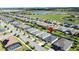 Neighborhood aerial view of well-maintained homes, lush landscaping, and ponds on a sunny day at 655 Conservation Blvd, Groveland, FL 34736