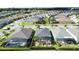 Aerial view of single-story homes with screened patios and lush landscaping in a residential neighborhood at 655 Conservation Blvd, Groveland, FL 34736