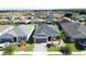 Beautiful gray single-story home with lush landscaping and gray roof, nestled in a residential neighborhood at 655 Conservation Blvd, Groveland, FL 34736