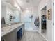 Contemporary bathroom featuring granite countertops, a glass shower, and easy access to the walk-in closet at 655 Conservation Blvd, Groveland, FL 34736