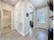 Inviting entryway with tile flooring, a decorative glass front door, and access to the bathroom at 655 Conservation Blvd, Groveland, FL 34736