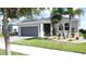 Beautiful single-story home with manicured lawn, stone-lined flowerbed, and a two-car garage at 655 Conservation Blvd, Groveland, FL 34736
