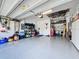 Well-organized garage with epoxy floor, ample storage, and a convenient workbench area for DIY projects and hobbies at 655 Conservation Blvd, Groveland, FL 34736