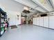 Spacious garage with epoxy flooring, built-in storage cabinets, and a well-organized layout for parking and storage at 655 Conservation Blvd, Groveland, FL 34736