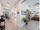 Open hallway leads to different rooms, featuring stylish decor and wood-look tile flooring at 655 Conservation Blvd, Groveland, FL 34736