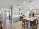 Modern kitchen with gray cabinets, stainless appliances, an island with bar seating, and stylish backsplash at 655 Conservation Blvd, Groveland, FL 34736
