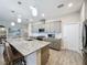 Modern kitchen with granite countertops, stainless appliances, and an island with bar seating at 655 Conservation Blvd, Groveland, FL 34736