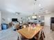Open-concept living space blending the dining room, living room, and kitchen with tile floors and natural light at 655 Conservation Blvd, Groveland, FL 34736
