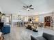 Open-concept living space with tile floors, a ceiling fan, and seamless flow into the dining area and kitchen at 655 Conservation Blvd, Groveland, FL 34736