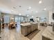 Open-concept living and dining space with an island and bar seating is showcased from a kitchen vantage at 655 Conservation Blvd, Groveland, FL 34736