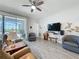 Relaxing living space with tile floors, stylish furniture, and sliding glass doors to the outdoor patio at 655 Conservation Blvd, Groveland, FL 34736