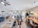 Bright open-concept layout connecting the living room, dining area, and kitchen with tile flooring throughout at 655 Conservation Blvd, Groveland, FL 34736