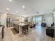 Open concept living space features a kitchen with a central island and dining and living room areas at 655 Conservation Blvd, Groveland, FL 34736